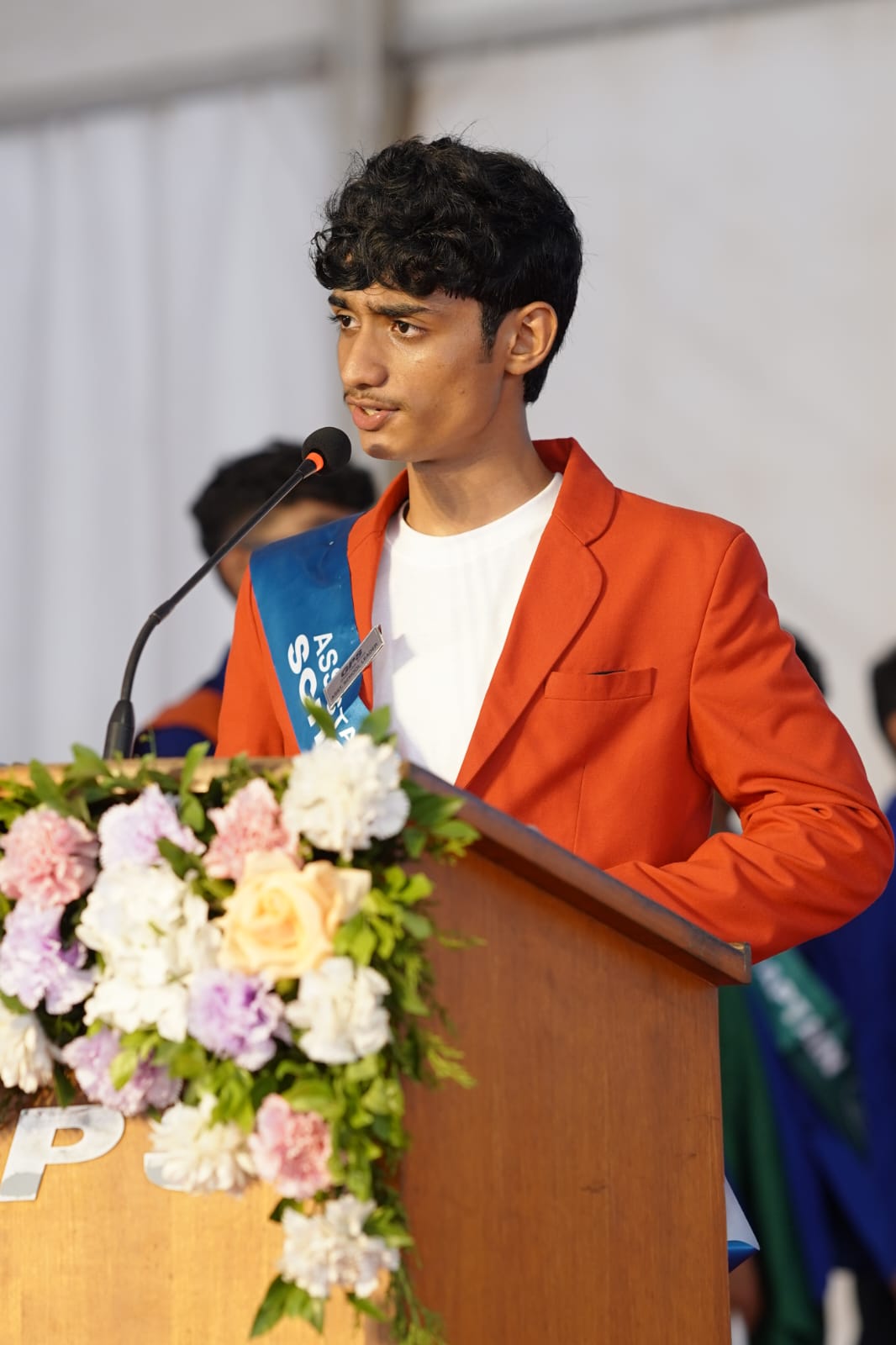 Portrait of Joel speaking at an event.